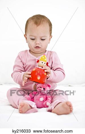 Baby girl playing with toys View Large Photo Image Stock Image - Baby girl playing with toys. Fotosearch