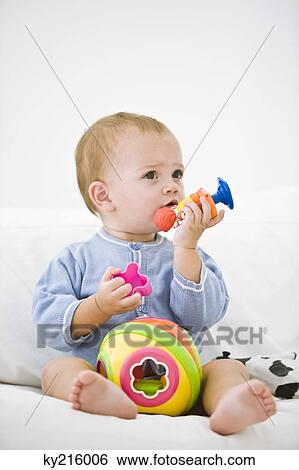 Baby girl playing with toys View Large Photo Image Stock Photograph - Baby girl playing with toys. Fotosearch