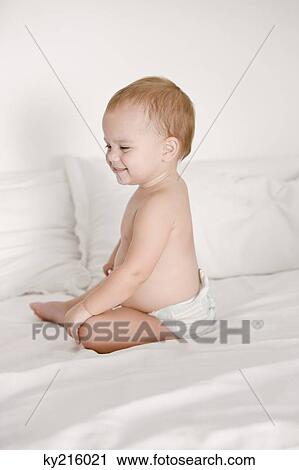 Baby girl smiling on the bed View Large Photo Image Stock Image - Baby girl smiling on the bed. Fotosearch