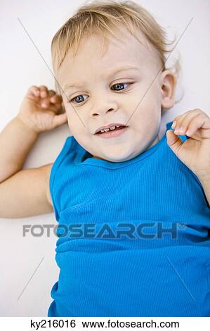 High angle view of a baby boy lying on the bed View Large Photo Image Stock Photograph - High angle view of a baby boy lying on the bed. Fotosearch