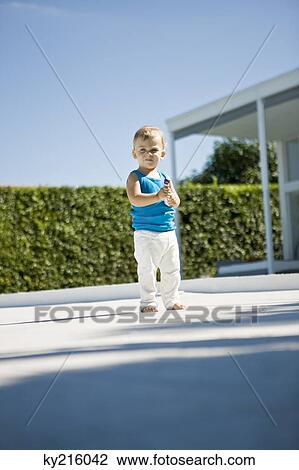 Portrait of a baby boy holding a toy car View Large Photo Image Stock Image - Portrait of a baby boy holding a toy car. Fotosearch