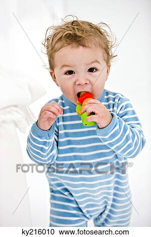 Portrait of a baby boy playing with a toy View Large Photo Image Stock Image - Portrait of a baby boy playing with a toy. Fotosearch