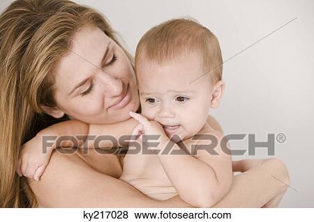Stock Photo - Close-up of a woman carrying her daughter. Fotosearch