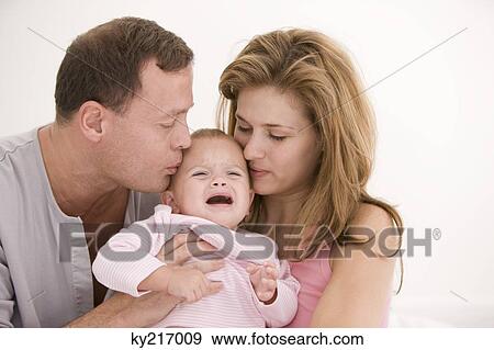 Parents consoling their crying daughter View Large Photo Image Stock Photo - Parents consoling their crying daughter. Fotosearch