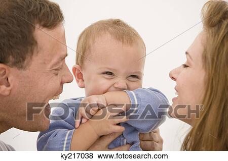 Parents pampering their daughter View Large Photo Image Stock Photo - Parents pampering their daughter. Fotosearch