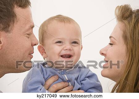 Parents pampering their daughter View Large Photo Image Stock Photo - Parents pampering their daughter. Fotosearch