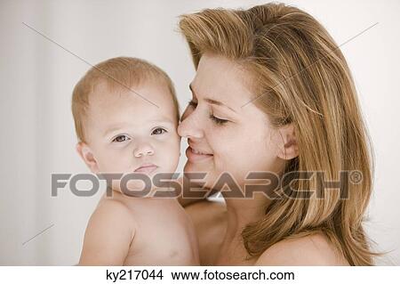 Woman carrying her daughter View Large Photo Image Picture - Woman carrying her daughter. Fotosearch