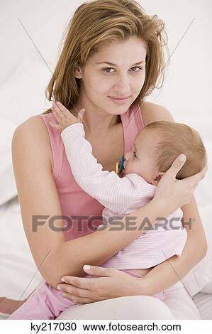 Woman carrying her daughter View Large Photo Image Stock Image - Woman carrying her daughter. Fotosearch