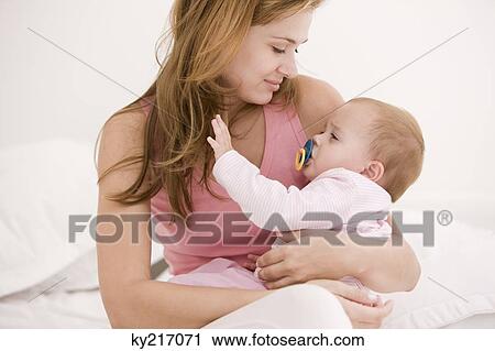 Woman carrying her daughter View Large Photo Image Stock Image - Woman carrying her daughter. Fotosearch