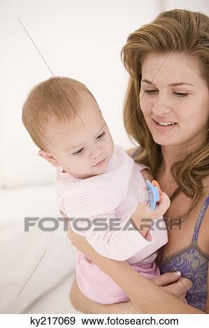 Woman carrying her daughter View Large Photo Image Stock Photo - Woman carrying her daughter. Fotosearch