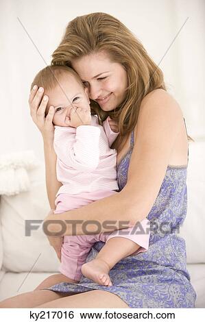 Woman carrying her daughter View Large Photo Image Stock Photograph - Woman carrying her daughter. Fotosearch