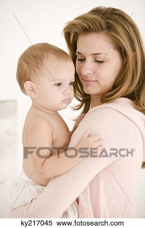 Woman carrying her daughter View Large Photo Image Stock Photography - Woman carrying her daughter. Fotosearch