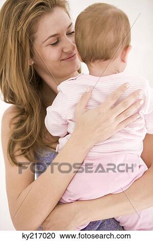 Woman holding her daughter View Large Photo Image Stock Image - Woman holding her daughter. Fotosearch