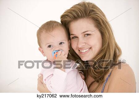 Woman holding her daughter View Large Photo Image Stock Image - Woman holding her daughter. Fotosearch