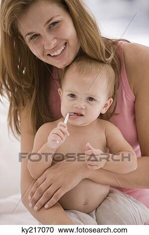 Woman holding her daughter View Large Photo Image Stock Image - Woman holding her daughter. Fotosearch