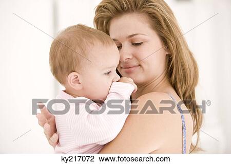 Woman holding her daughter View Large Photo Image Stock Image - Woman holding her daughter. Fotosearch