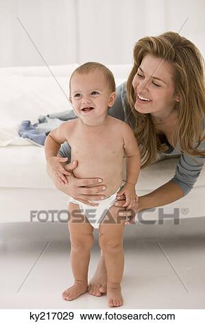 Woman holding her daughter View Large Photo Image Stock Photo - Woman holding her daughter. Fotosearch