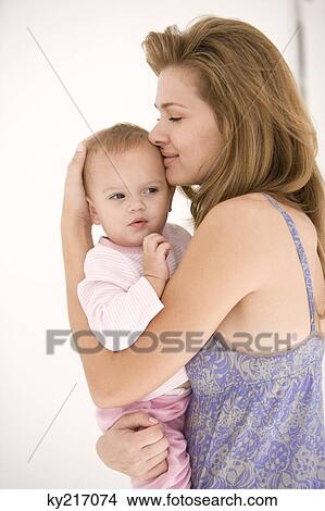 Woman hugging her daughter View Large Photo Image Picture - Woman hugging her daughter. Fotosearch