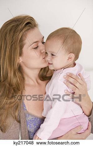 Woman kissing her daughter View Large Photo Image Stock Photo - Woman kissing her daughter. Fotosearch
