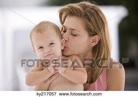 Stock Photo - Woman kissing her daughter. Fotosearch