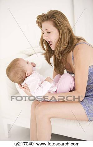 Woman playing with her daughter View Large Photo Image Stock Image - Woman playing with her daughter. Fotosearch