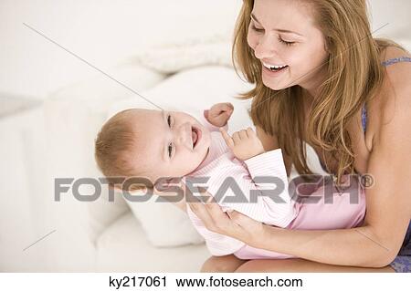 Woman playing with her daughter View Large Photo Image Stock Image - Woman playing with her daughter. Fotosearch