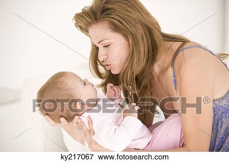 Woman playing with her daughter View Large Photo Image Stock Photo - Woman playing with her daughter. Fotosearch