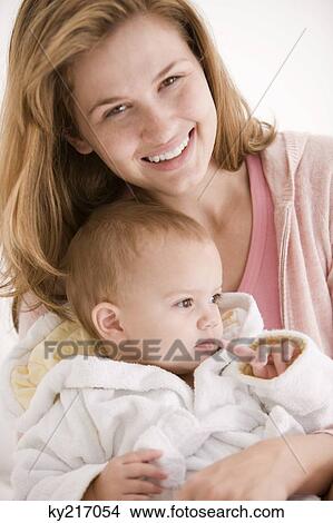 Woman smiling with her daughter View Large Photo Image Picture - Woman smiling with her daughter. Fotosearch