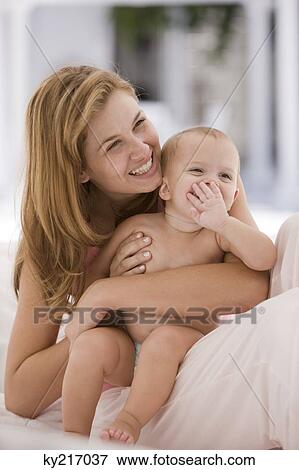 Stock Photo - Woman smiling with her daughter. Fotosearch