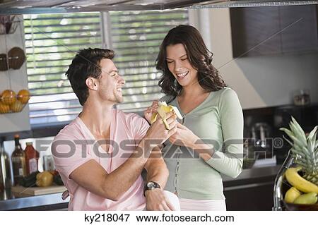 Couple eating a banana View Large Photo Image Stock Photo - Couple eating a banana. Fotosearch