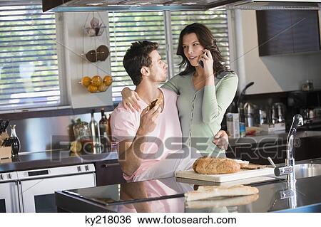 Couple in the kitchen View Large Photo Image Stock Photograph - Couple in the kitchen. Fotosearch