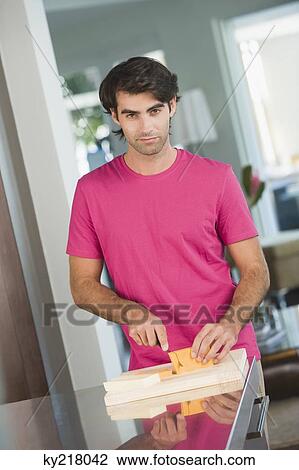 Man cutting cheese slices View Large Photo Image Stock Image - Man cutting cheese slices. Fotosearch