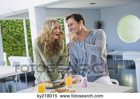 Man feeding fruit salad to his wife View Large Photo Image Stock Photography - Man feeding fruit salad to his wife. Fotosearch