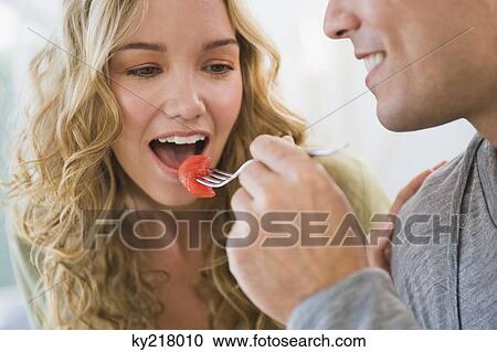 Man feeding strawberry to his wife View Large Photo Image Stock Image - Man feeding strawberry to his wife. Fotosearch
