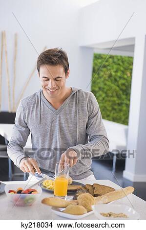 Man having breakfast View Large Photo Image Picture - Man having breakfast. Fotosearch