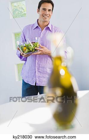 Man holding a bowl of salad and smiling View Large Photo Image Stock Image - Man holding a bowl of salad and smiling. Fotosearch