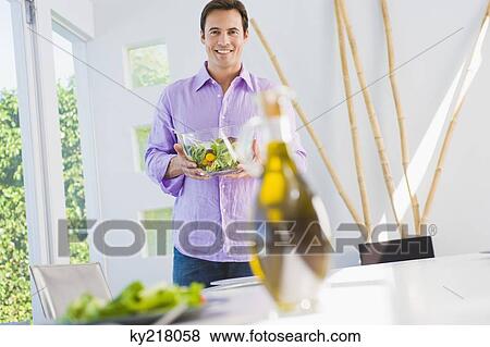 Man holding a bowl of salad and smiling View Large Photo Image Stock Photo - Man holding a bowl of salad and smiling. Fotosearch