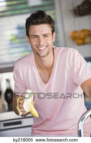 Portrait of a man eating a banana View Large Photo Image Stock Photography - Portrait of a man eating a banana. Fotosearch