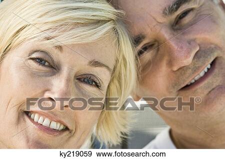 Close-up of a couple smiling View Large Photo Image Stock Photo - Close-up of a couple smiling. Fotosearch