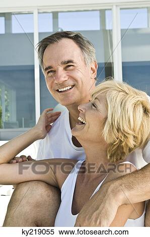 Close-up of a couple smiling View Large Photo Image Stock Photography - Close-up of a couple smiling. Fotosearch