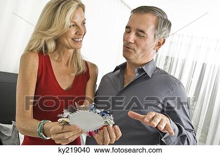 Couple choosing color from a color swatch View Large Photo Image Stock Image - Couple choosing color from a color swatch. Fotosearch