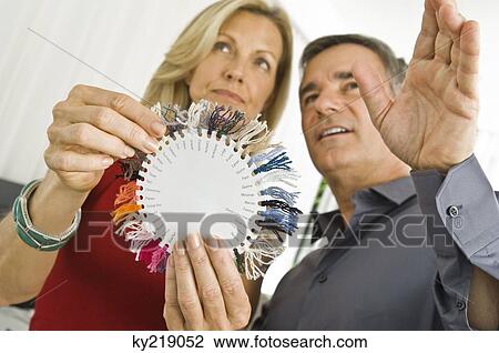 Couple choosing color from a color swatch View Large Photo Image Stock Image - Couple choosing color from a color swatch. Fotosearch