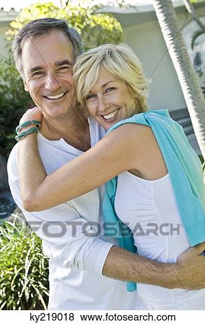 Stock Photo - Couple embracing each other and smiling. Fotosearch