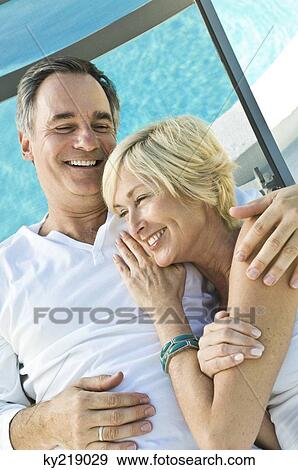 Stock Photo - Couple embracing each other and smiling. Fotosearch