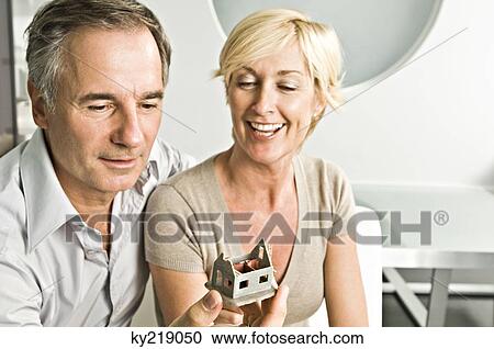 Couple looking at a model home View Large Photo Image Stock Image - Couple looking at a model home. Fotosearch