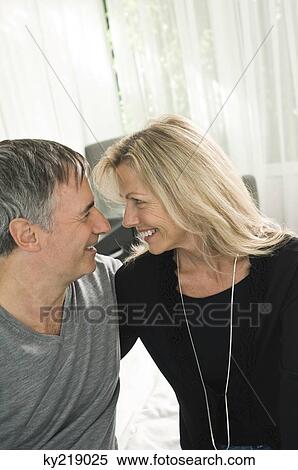 Stock Photography - Couple looking at each other and smiling. Fotosearch