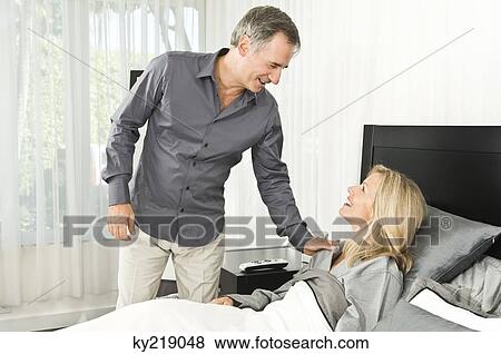 Stock Photo - Man assisting his ill wife. Fotosearch