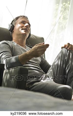 Stock Photograph - Man listening to music with headphones. Fotosearch
