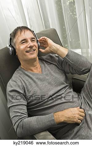 Stock Photograph - Man listening to music with headphones. Fotosearch