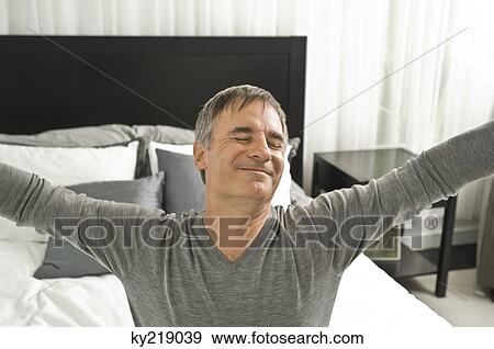 Man stretching in the bed View Large Photo Image Stock Photo - Man stretching in the bed. Fotosearch
